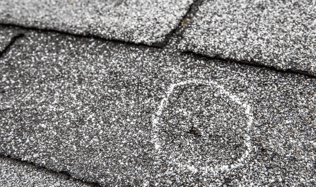 A close up of the top of a roof with snow on it