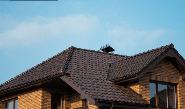 A brown roof with a sky background