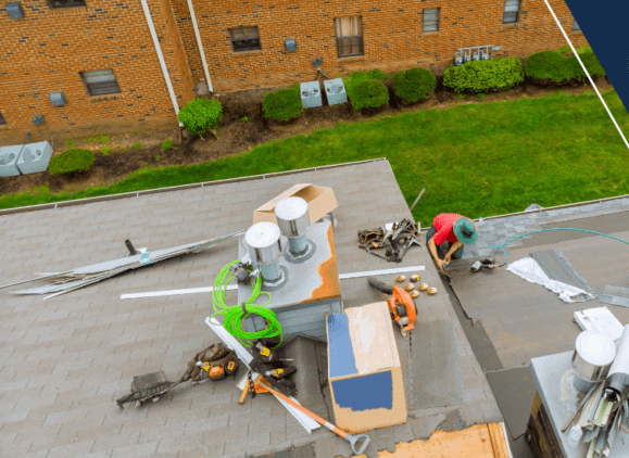 A group of people working on the roof of a building.