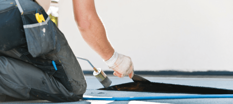 A person is painting the floor of an apartment.