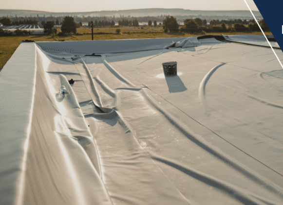 A white tarp covering the roof of a building.