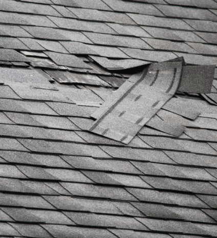 A black and white photo of a damaged roof.