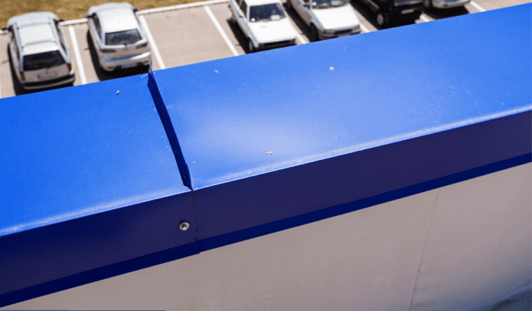 A blue box on the side of a building.