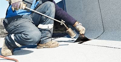 A person working on the roof of a building.